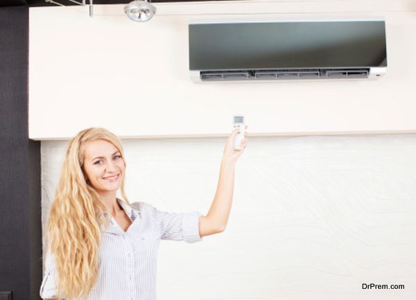 Female holding a remote control air conditioner